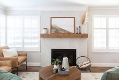 a living room filled with furniture and a fire place in front of a tv mounted on a wall