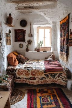 a room with a bed, rugs and windows on the walls is shown in this image