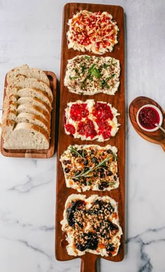 the butter board is filled with different types of breads and jams on it