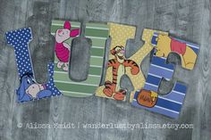 wooden letters with winnie the pooh and tigger on them