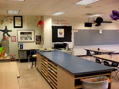 an empty classroom with desks, chairs and chalkboards on the wall in front of it