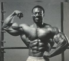 a black and white photo of a man flexing his muscles