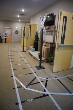 there is a railroad crossing on the floor in an office building that has been taped off with tape