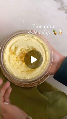 a person holding a bowl with some food in it and the text pineapple hot whip