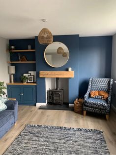 a living room filled with furniture and a fire place under a mirror on the wall