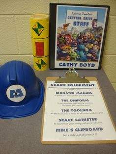 there is a hard hat and safety equipment on the table next to it's sign