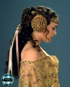 a woman with long hair wearing a head piece