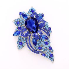 "Gorgeous large crystal royal blue brooch wedding jewelry embellishment, which can be used for your DIY project - dress sash accessory, ring pillow, photo album, cake and frame decor, crafts, event decor, scrap booking, jewelry gift and much more! Size: 3 1/2\"H x 2 1/2\"W Stones color: Royal blue, sky blue Metal color: Silver plated This beautiful rhinestone sapphire blue broach can be ordered with pin in the back to add to wedding gown or dress sash, to wire into brooch bouquet, or any number Album Cake, Blue Brooch, Brooch Wedding, Dress Sash, Brooch Bouquet, Ring Pillow, Large Crystal, Dress Pin, Crystal Blue