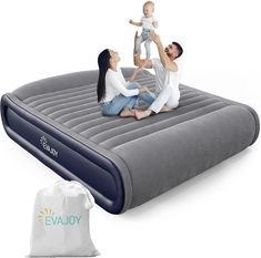 an inflatable mattress with two people and a baby sitting on it next to a bag