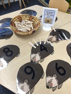 an animal themed table with place mats for the number six, and a basket of matches