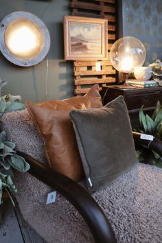 a bed with some pillows on top of it next to a lamp and other items