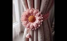 the curtain is decorated with pink flowers and tassels on it's side