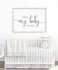 a white crib with a quote on the wall above it