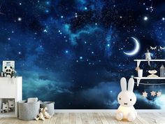 a child's room with a night sky wallpaper and stars in the background