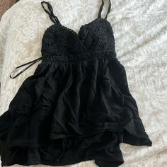 Forever 21 Black Tank Top With Tie Bow. Never Worn With Tags Flirty Black Top With Spaghetti Straps, Black Spaghetti Strap Flirty Top, Flirty Black Spaghetti Strap Top, Black Spaghetti Strap Summer Tops, Black Spaghetti Strap Top For Day Out, Forever 21 Tops, Black Tank Tops, Forever 21, Womens Tops