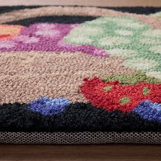 a multicolored area rug with flowers on it