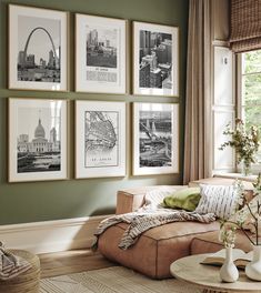 a living room with green walls and pictures on the wall above the couch, along with vases filled with flowers