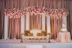 a couch sitting under a flower covered stage