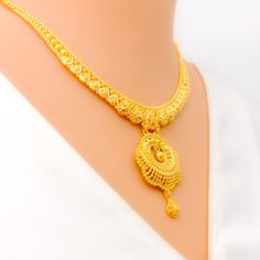 This 22k gold necklace set is a mesmerizing display of artistry, featuring intricate peacock feather accents that evoke elegance and grace. Weighing 32.0 grams, the set is crafted in radiant yellow gold with a 16-inch necklace, adjustable by 1.75-inch links, and secured with a hook lock. The matching earrings, 1.75 inches in length, include screw-back posts for secure and comfortable wear. The detailed peacock feather design adds a unique and luxurious touch, making this set ideal for those who appreciate sophisticated, nature-inspired jewelry, perfect for special occasions. PRODUCT DETAILS Gold Purity(karat): 22k Gold Weight(grams): 32.0 Item Finish: Yellow Gold Set Length: 16" Drop Length: 1.5" Adjustable Links: 1.75" Links Lock Style: Hook Lock Matching Earrings: Included Earring Length 22k Gold Necklace Set, Peacock Feather Design, 22k Gold Necklace, Indian Rings, Bridal Jewelry Necklace, Precious Stones Rings, Diamond Pendant Sets, 16 Inch Necklace, Fancy Necklace