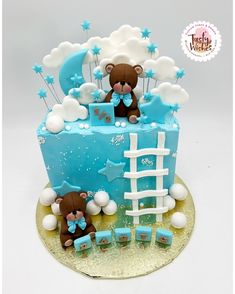 a blue and white cake with teddy bears on it