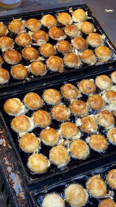 three trays filled with food sitting on top of a table next to each other