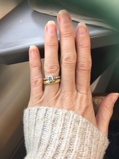 a woman's hand with a ring on it