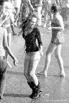 black and white photograph of people walking in the rain