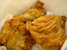 three fried food items in a white basket