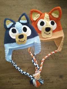 two crocheted hats with animals on them, one is blue and the other is orange