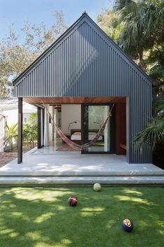 a house with a hammock in the yard