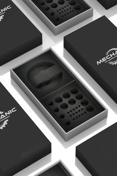 several black and white boxes with different designs on the front, one is open to reveal an electronic device