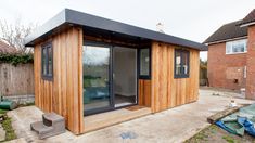 a small wooden building sitting in the middle of a yard