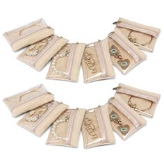 a set of seven purses with necklaces and bracelets in each bag on a white background