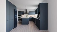 an empty kitchen with blue cabinets and white counter tops is seen in this image from the hallway to the dining room