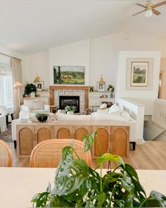 a living room filled with furniture and a fire place in the middle of a room