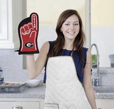 a woman holding an oven mitt in her hand