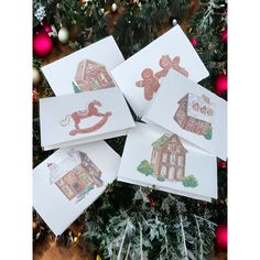 four christmas cards on top of a tree