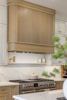 a kitchen with white counter tops and wooden cabinets, along with a stove top oven