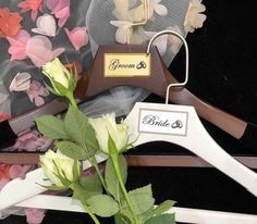 a bouquet of roses sits next to a wedding hanger