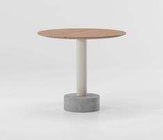 a small round table with a white base and wooden top, on a plain surface