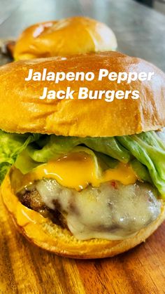 a cheeseburger with lettuce and other toppings on a wooden table