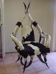 a chair made to look like a spider with horns on it's back and legs