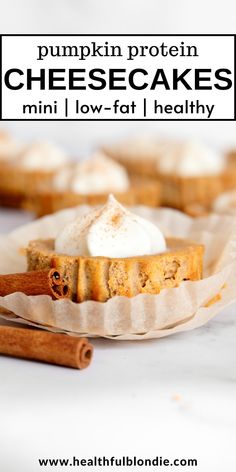 mini pumpkin protein cheesecakes with cinnamon and whipped cream in the middle on a paper plate