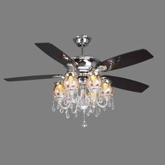 a ceiling fan with three lights and a chandelier hanging from it's blades