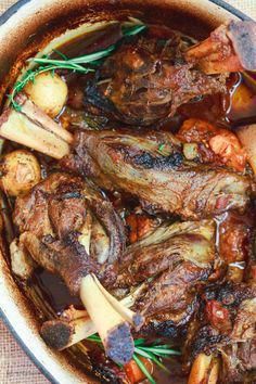 a pot filled with meat and vegetables on top of a table