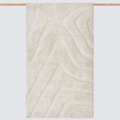 a white rug with wavy lines on it