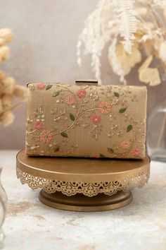 "Our Floral creeper clutches are super-hot, year-round! The traditional silhouette with exquisite floral embroidery and the metal chain sling are perfect to add that oomph to your overall look and make a strong style statement, no matter what the occasion. Embroidered front and back. Dimensions (LxB): 8\"x4.5\" (20 cm x 11 cm) Handle length: 47\" (120 cm) Handle drop: 23\" (58 cm) Material: Embroidered poly silk, poly satin lining, gold metal clutch frame, gold metal sling. Features: metal lock closure, detachable metal sling" Elegant Gold Embroidered Fabric For Diwali, Elegant Formal Floral Embroidered Fabric, Elegant Floral Embroidered Fabric For Evening, Elegant Intricate Embroidery Fabric For Evening, Elegant Formal Embroidered Fabric, Formal Floral Embroidered Fabric, Elegant Multicolor Embroidered Fabric For Diwali, Elegant Formal Embroidered Fabric With Intricate Embroidery, Elegant Floral Embroidered Festive Fabric