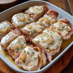 some food is in a white dish on a wooden table