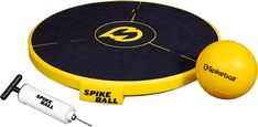 a yellow and black frisbee is next to a white ball with the word spike ball on it