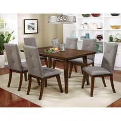 a dining room table and chairs with white rug